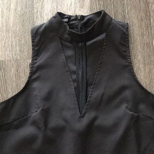 Black top with high neck and opening.